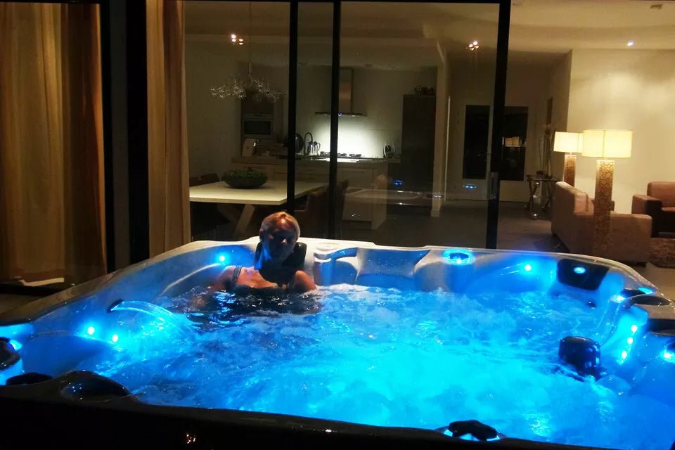 Evening relaxation in Admire spa with illuminated blue LED lights, showcasing therapeutic jets and spacious interior - Passion Spas Hot Tubs
