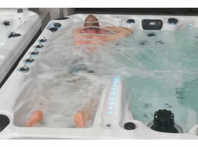 Euphoria spa with Levitation Bed massage system in action, showing steamy water and multiple massage jets - Passion Spas Exclusive Collection