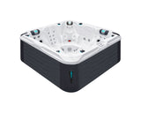 Delight luxury hot tub with white acrylic shell, black cabinet, dual loungers and aqua accents - Passion Spas Signature Hot Tubs