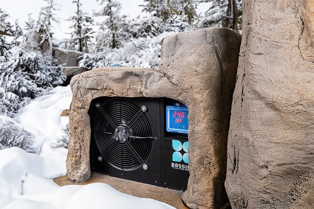 Rock-inspired outdoor ice bath 'Faith' with integrated cooling system nestled in snowy winter landscape - Passion Ice Baths Ice bath collection