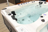 Fitness 1 Deep swim spa with blue jets and crystal water on wooden deck, featuring Current-Lift Technology - Passion Spas Fitness Collection