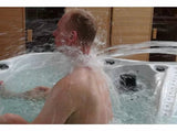 A person enjoying powerful water jets in the Euphoria spa, demonstrating the Waterfall Massage feature - Passion Spas Exclusive Collection