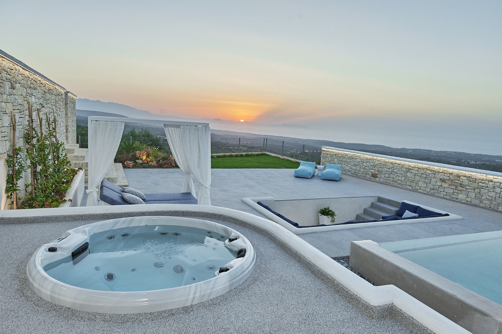 Recharge round spa at sunset with mountain views, luxury outdoor seating and canopy bed - Passion Spas Pure Collection Hot Tubs