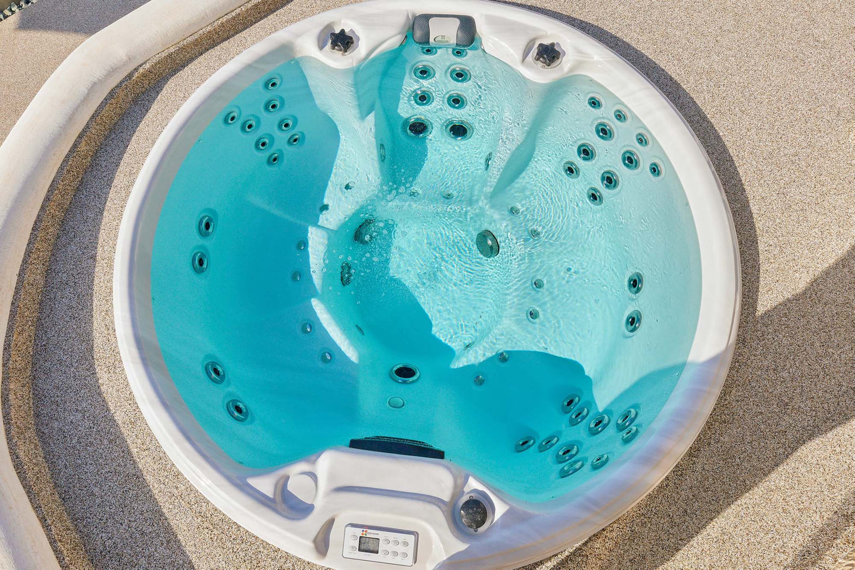 Recharge round hot tub with turquoise water, multiple massage jets, aerial view of 5-person spa seating - Passion Spas Pure Collection Hot Tubs